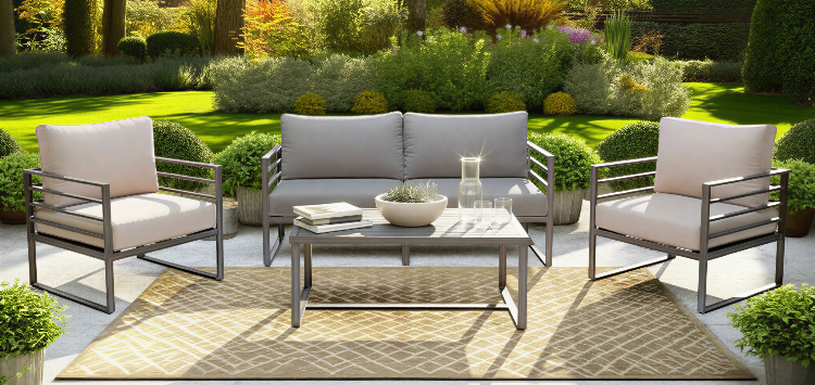 Outdoor patio set with chairs, table, and cushions in a garden setting