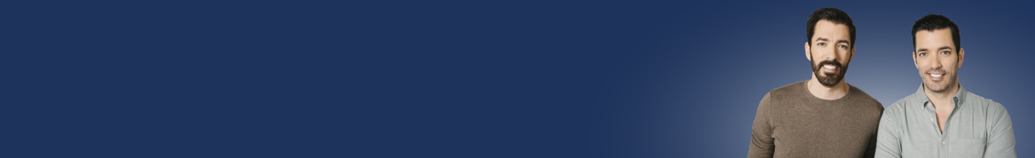 Two men standing side by side against a solid dark blue background, with the left side of the image featuring a large blank blue space.